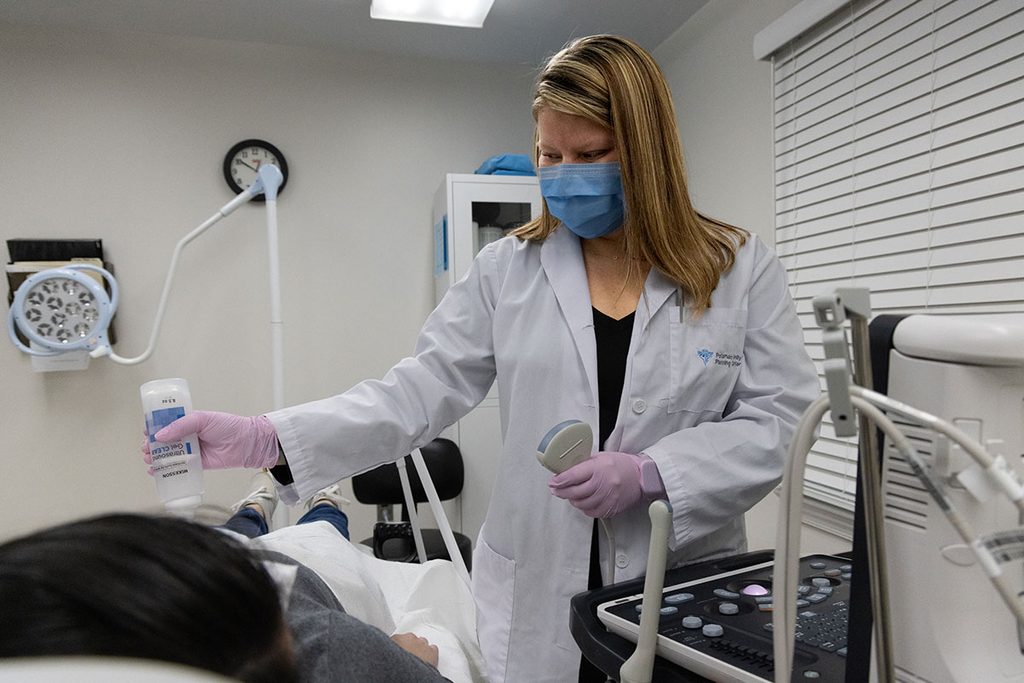 Women getting ultrasound at clinic